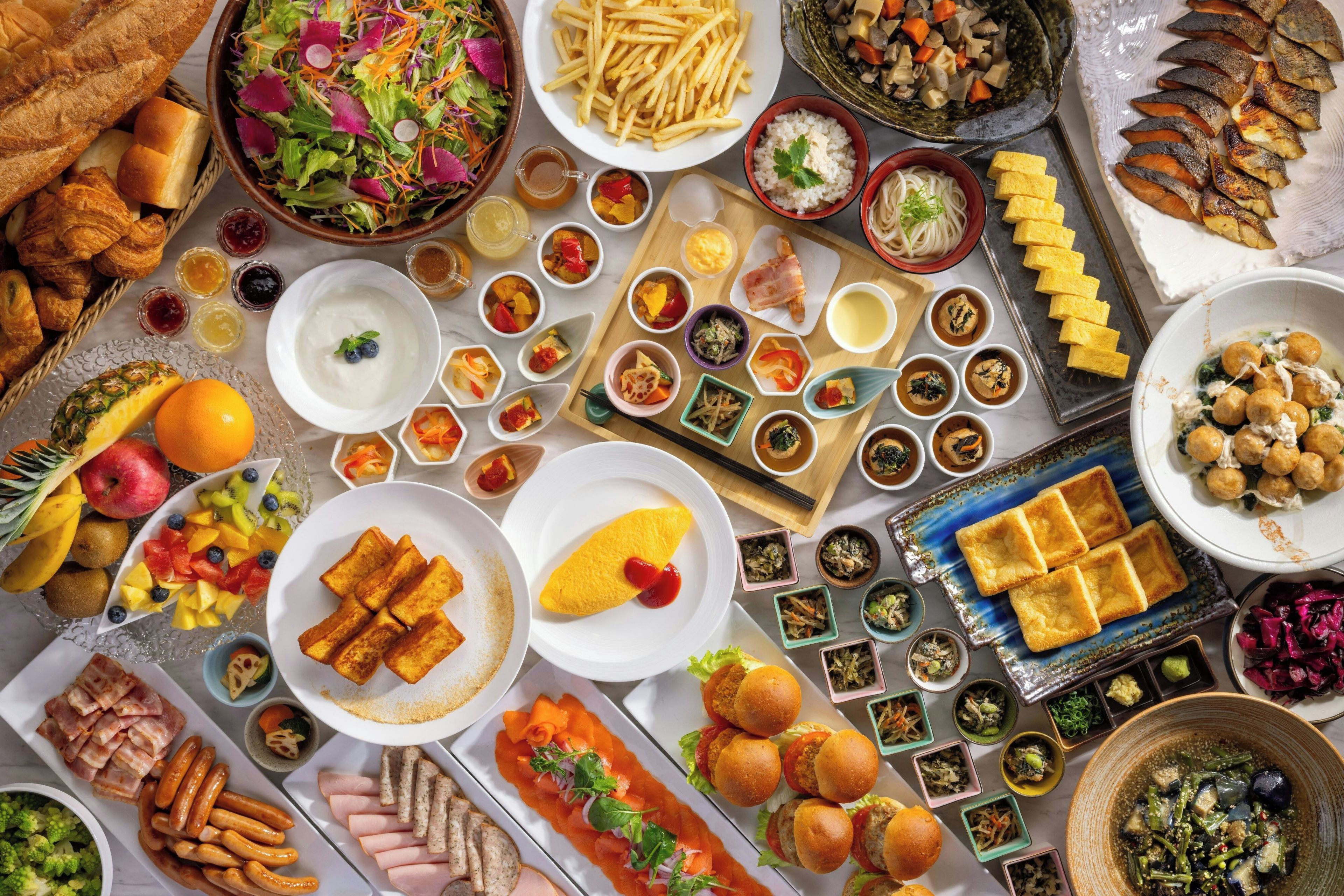 A variety of food items including salads, bread, and meats, suggesting a buffet-style meal.