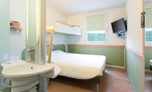 Cozy retreat with a bunk bed and single bed, featuring a mounted TV and a bedside table.