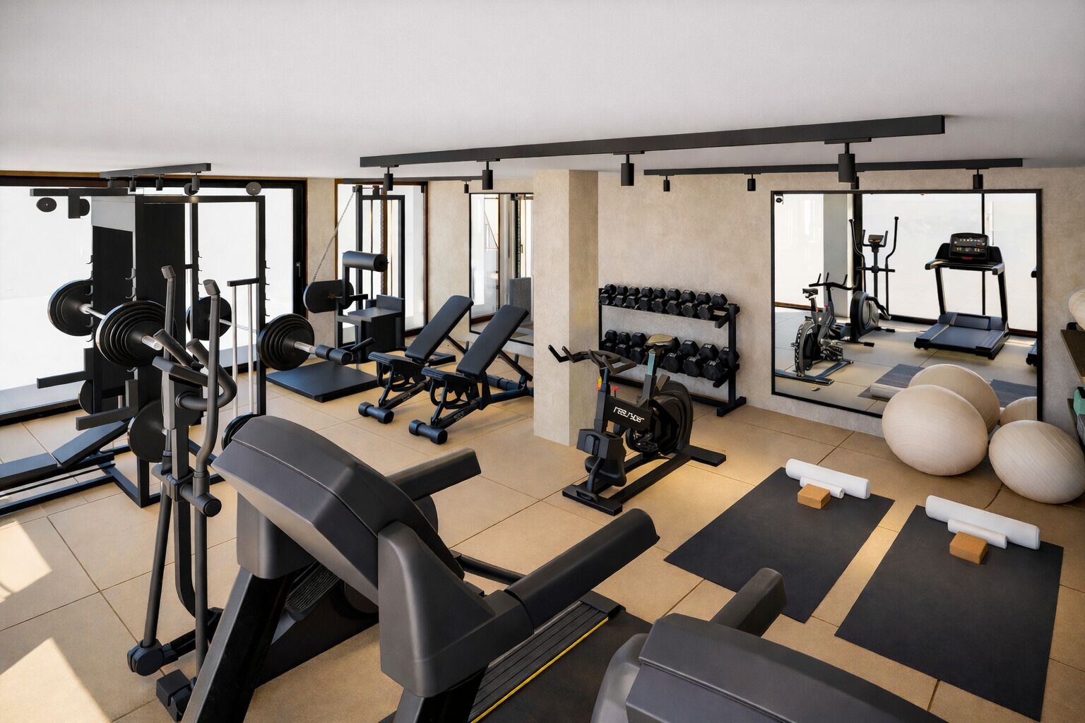 Une salle de sport équipée de divers appareils d’entraînement, notamment des appareils de musculation, des poids libres et des appareils de cardio.