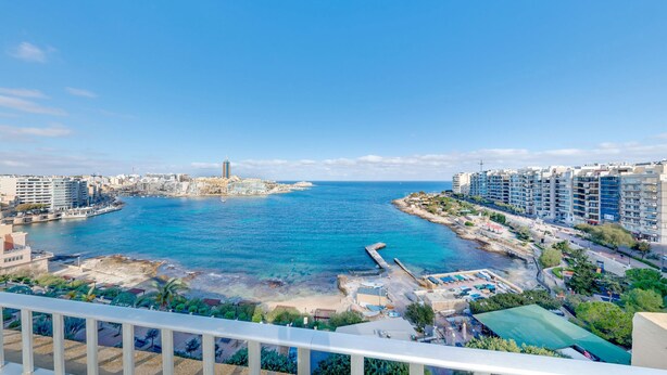 A coastal cityscape with a marina, high-rise buildings, and a clear blue sky. - Carlton Hotel (Sliema)