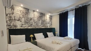 A hotel room with two beds, a mural, and a view of the outside. - Carlton Hotel (Sliema)