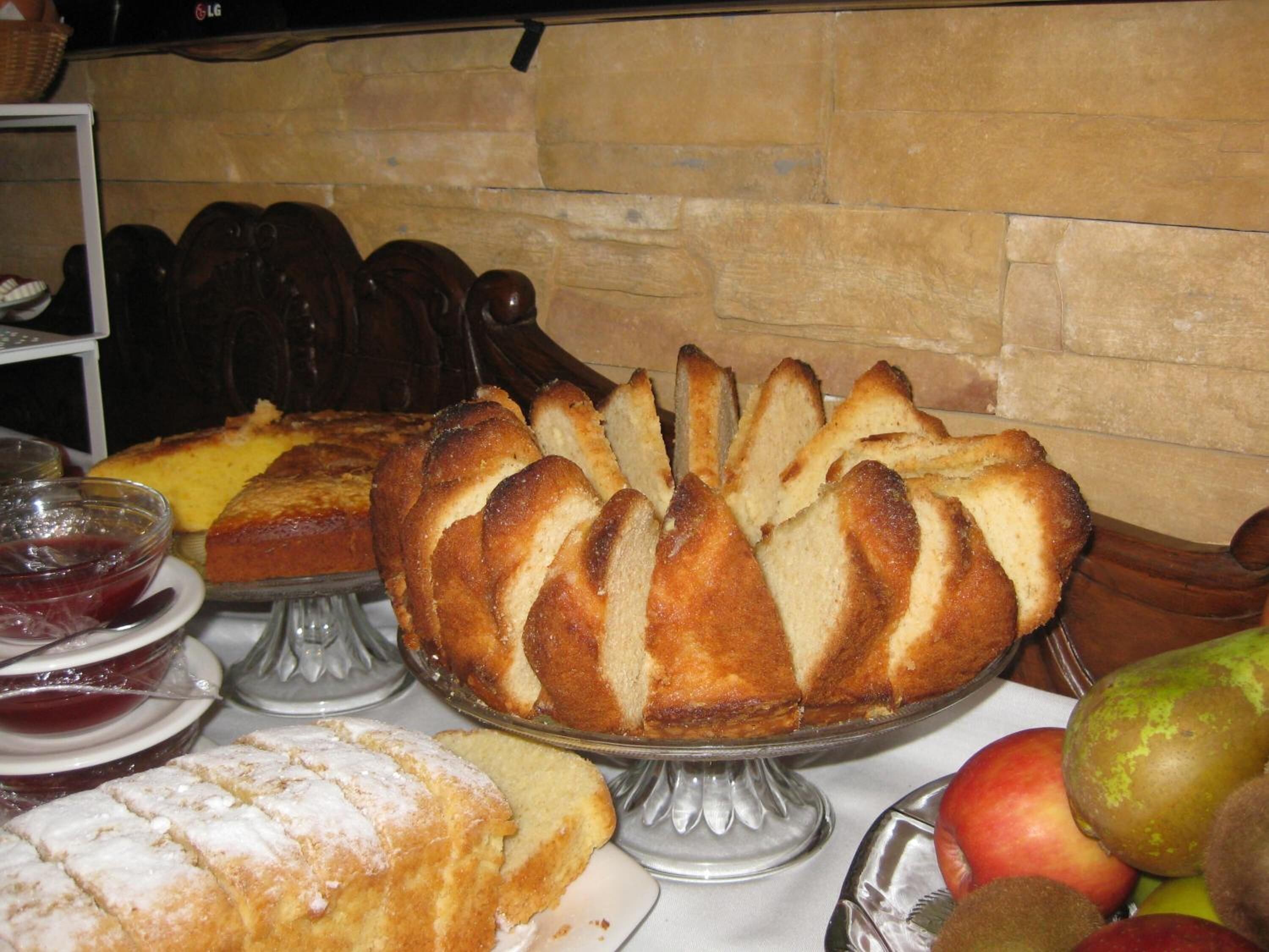 A table with various baked goods and fruits.
