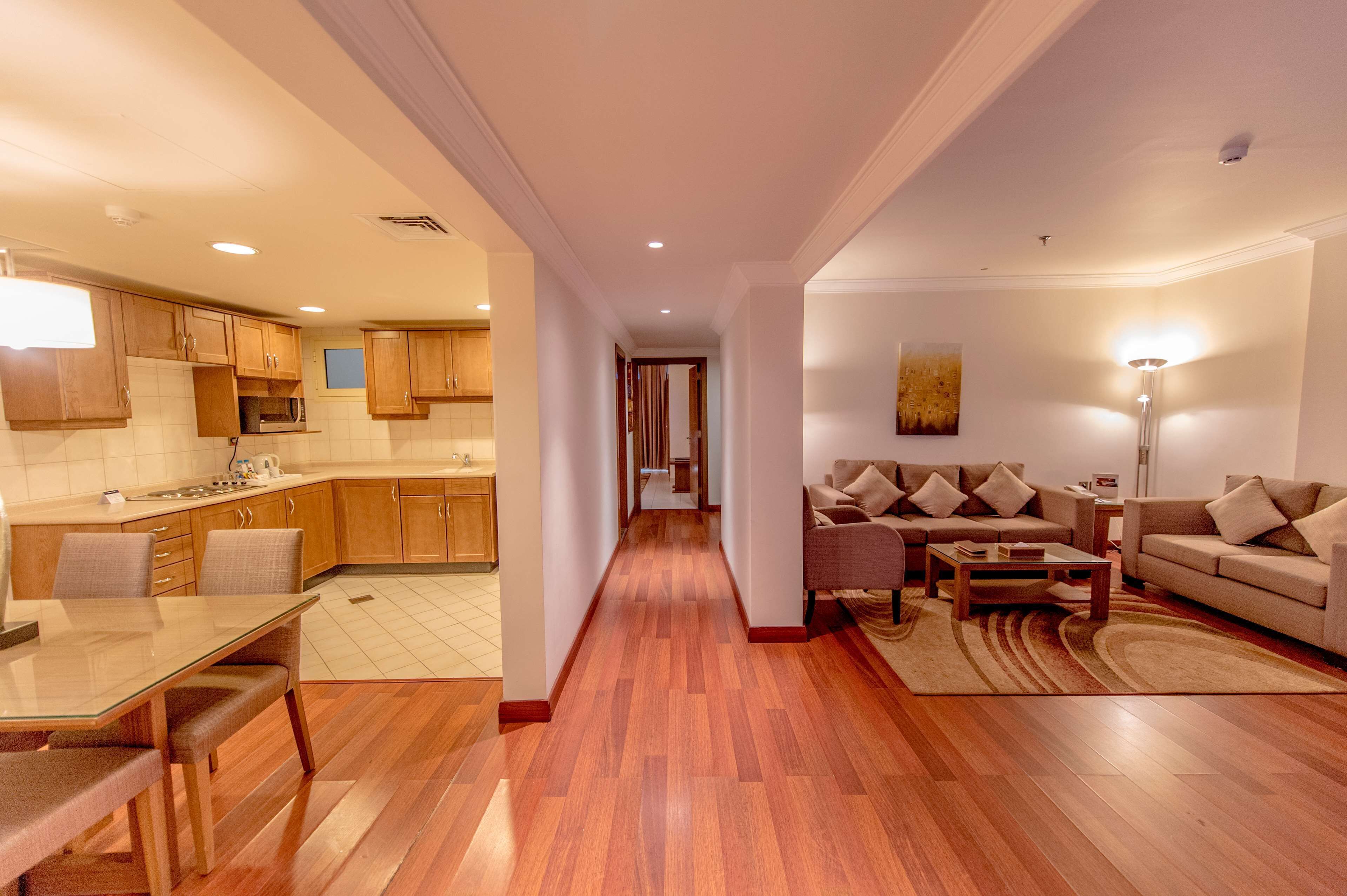 A modern apartment with a kitchen, dining area, and living room.