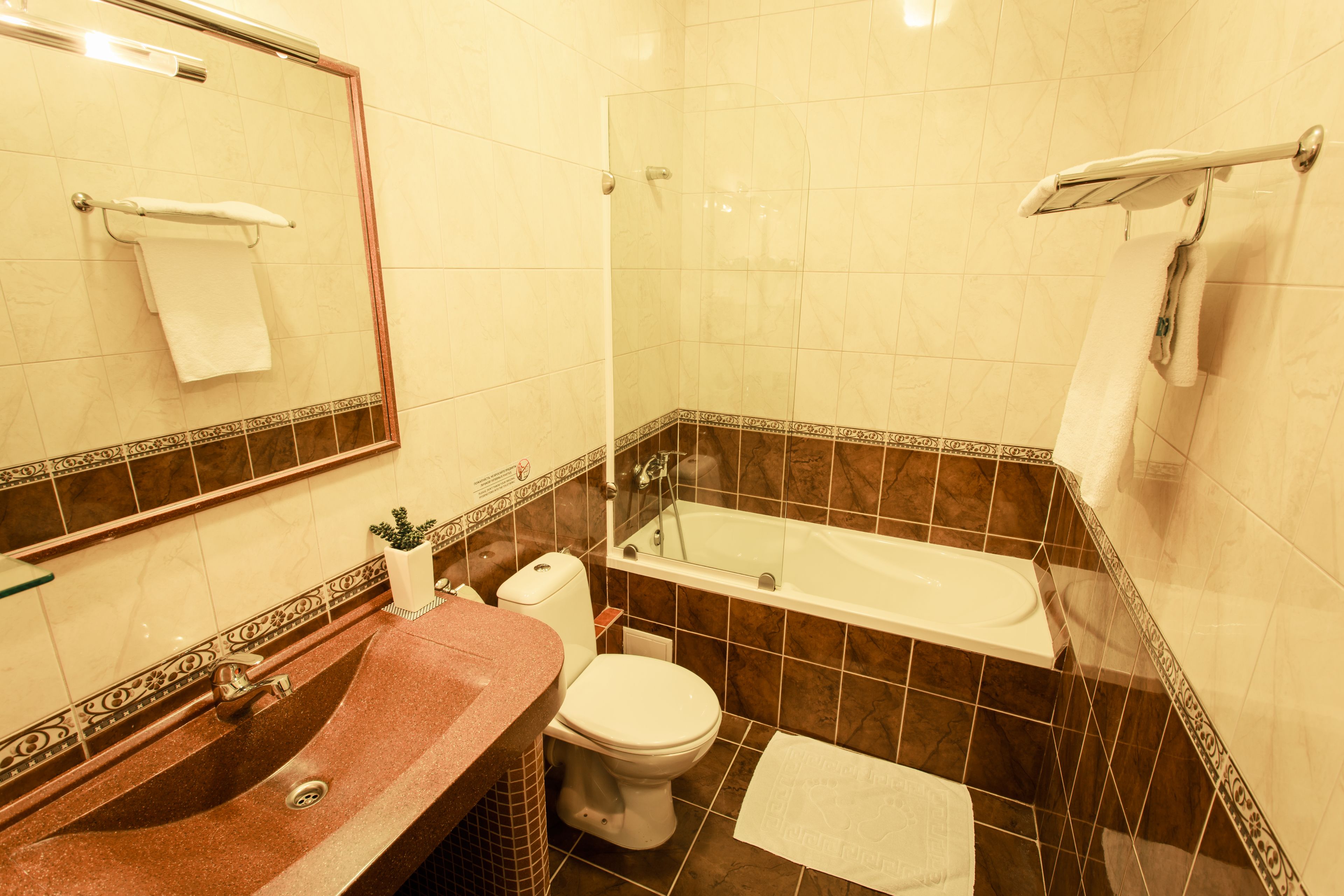 A bathroom with a sink, toilet, and bathtub.