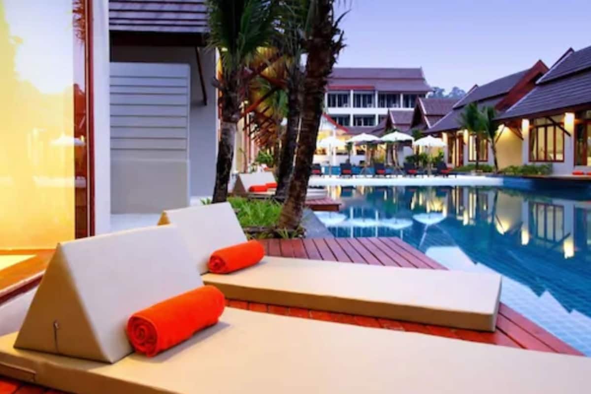 A poolside lounge area with sun loungers and a pool.