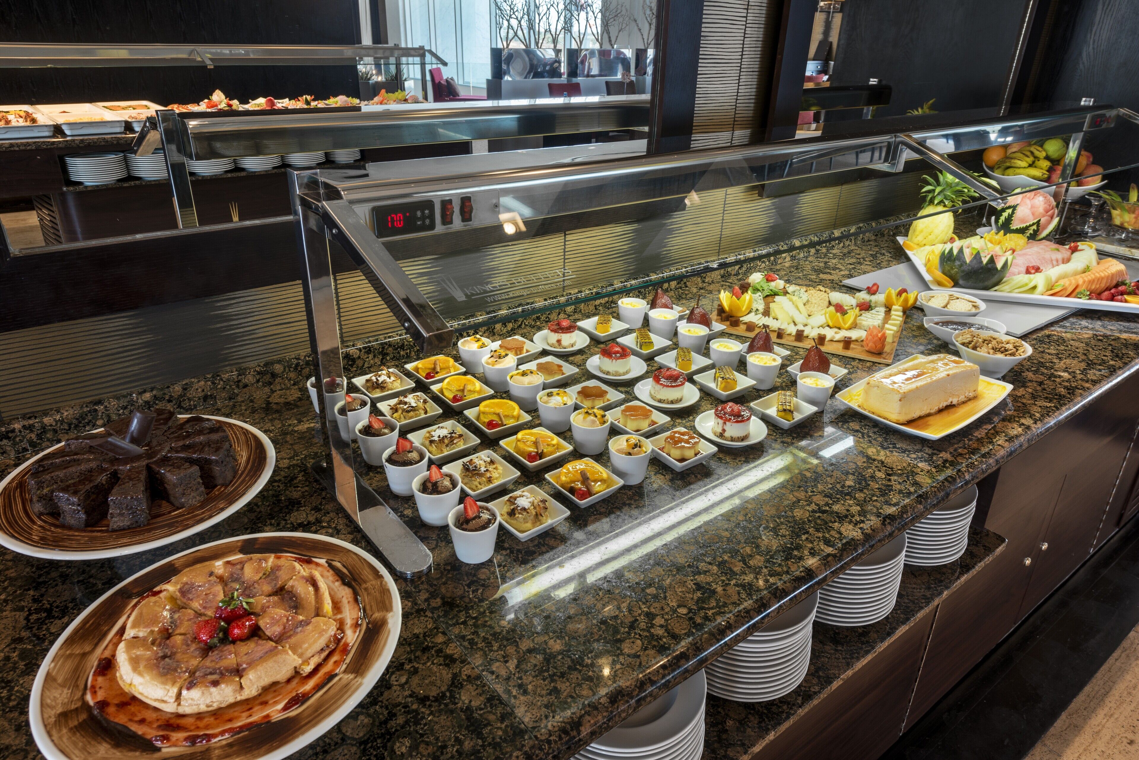 A buffet with various dishes and desserts.