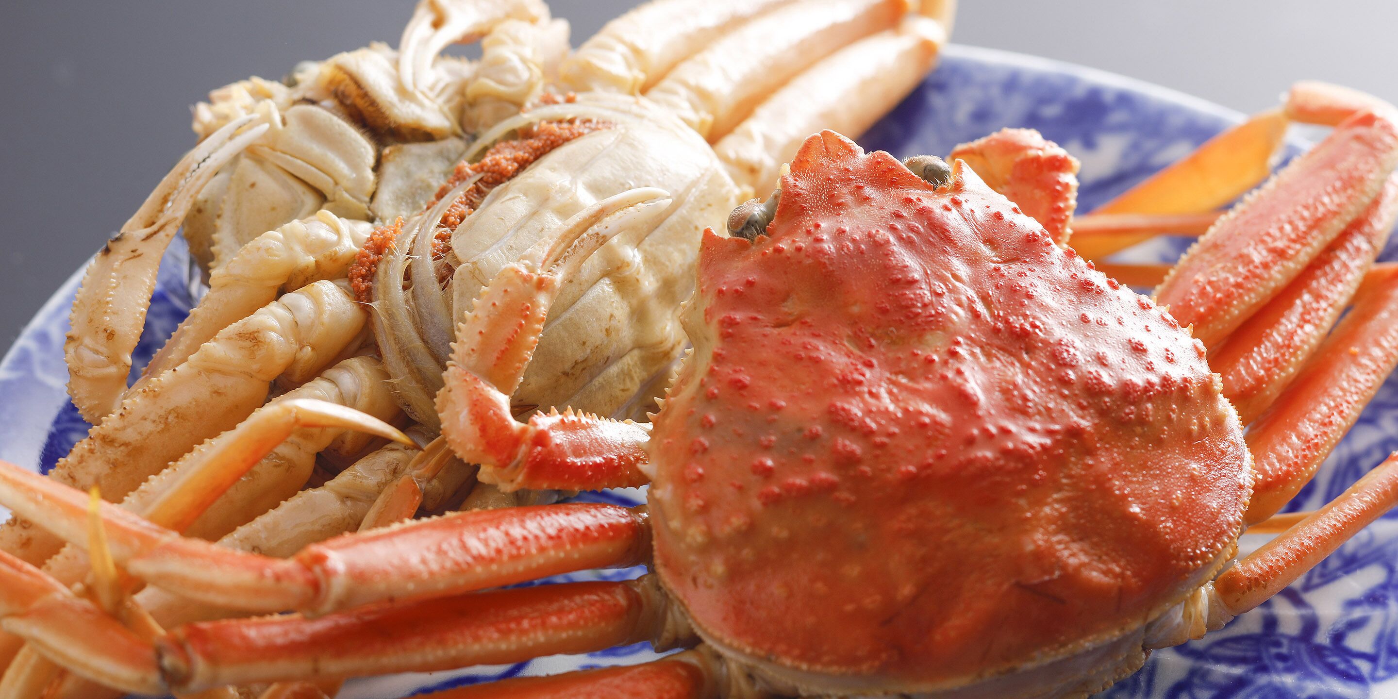 A plate of cooked crab legs and claws.