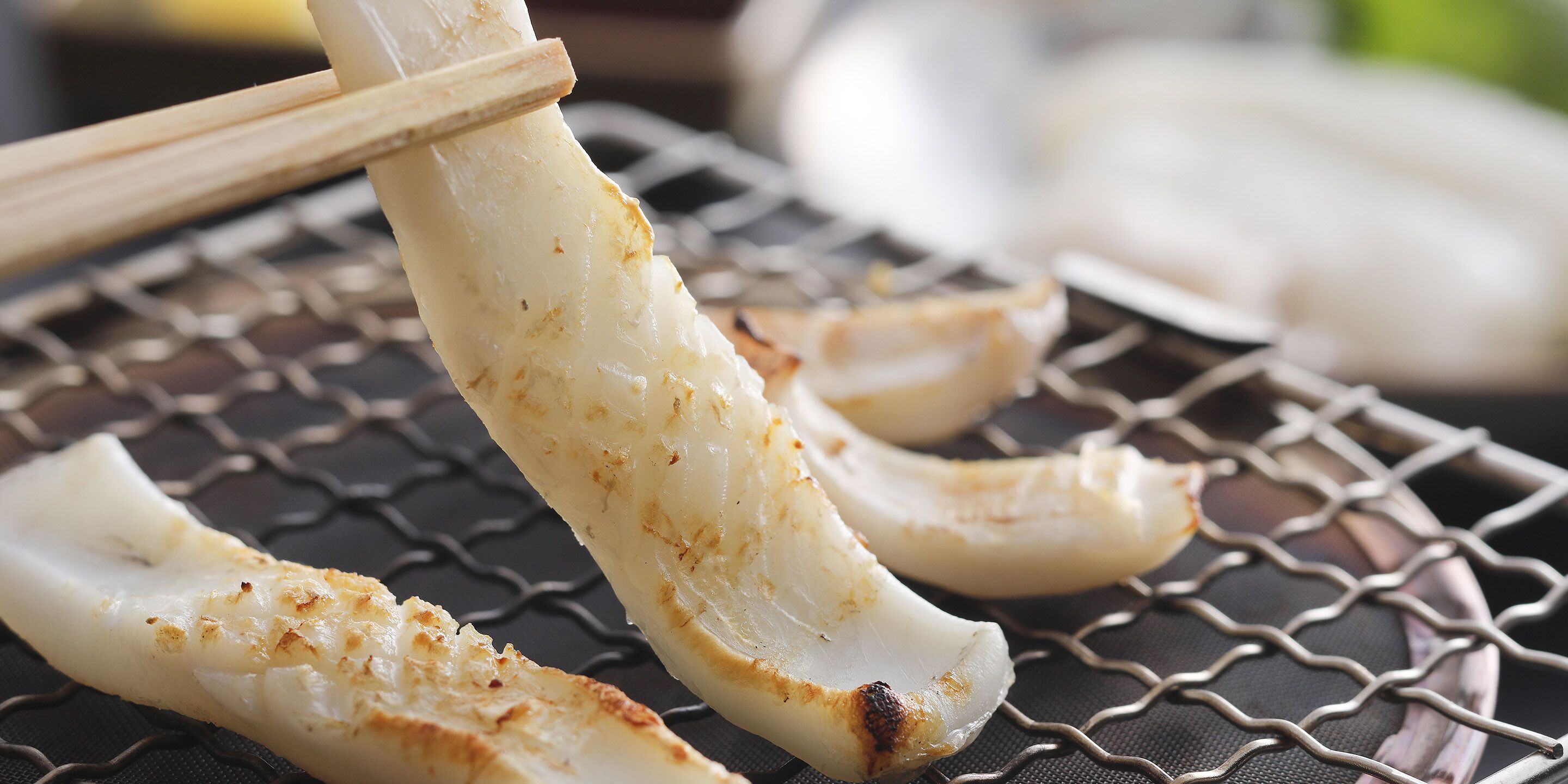 Grilled squid on a wire rack.