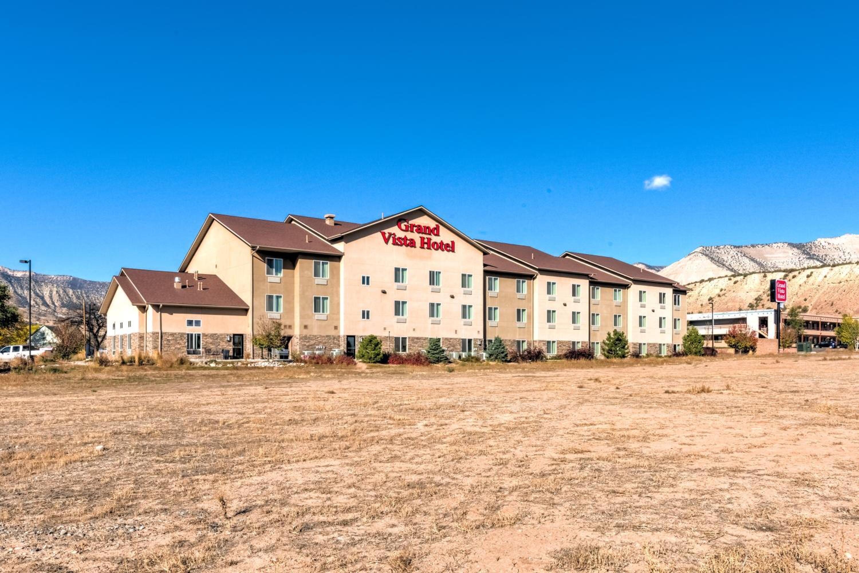 A Grand Vista Hotel with a modern design, multiple floors, and a flat roof.