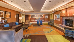 A hotel lobby with a reception desk, seating area, and fireplace. - Grand Vista Hotel Parachute (Parachute)