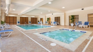 An indoor swimming pool with two lanes, lounge chairs, and a seating area with tables and chairs. - Hampton Inn & Suites Detroit/Chesterfield Township (New Baltimore)