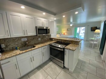 Oceanfront King Suite w/ Kitchen & Private Balcony | 1 bedroom, premium bedding, individually decorated at Drop Anchor