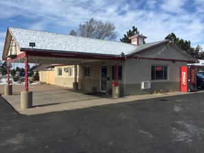 A small, single-story building with a red roof and a Coca-Cola sign.