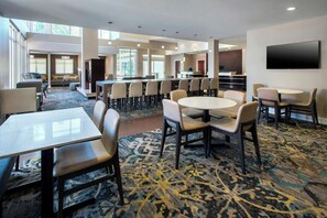 A hotel lobby with a large seating area, a reception desk, and a flat-screen TV mounted on the wall. - Residence Inn by Marriott Pittsburgh Monroeville/Wilkins (Pittsburgh)