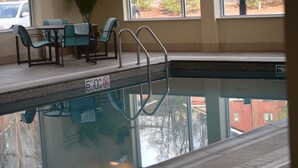 A pool area with a 5 ft depth sign, a pool ladder, and a seating area with chairs and a table. - Residence Inn by Marriott Pittsburgh Monroeville/Wilkins (Pittsburgh)