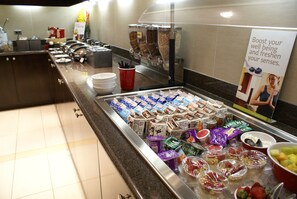 Enjoy a wide selection of food and beverages at our buffet, featuring a variety of fresh fruits, cheeses, and snacks.