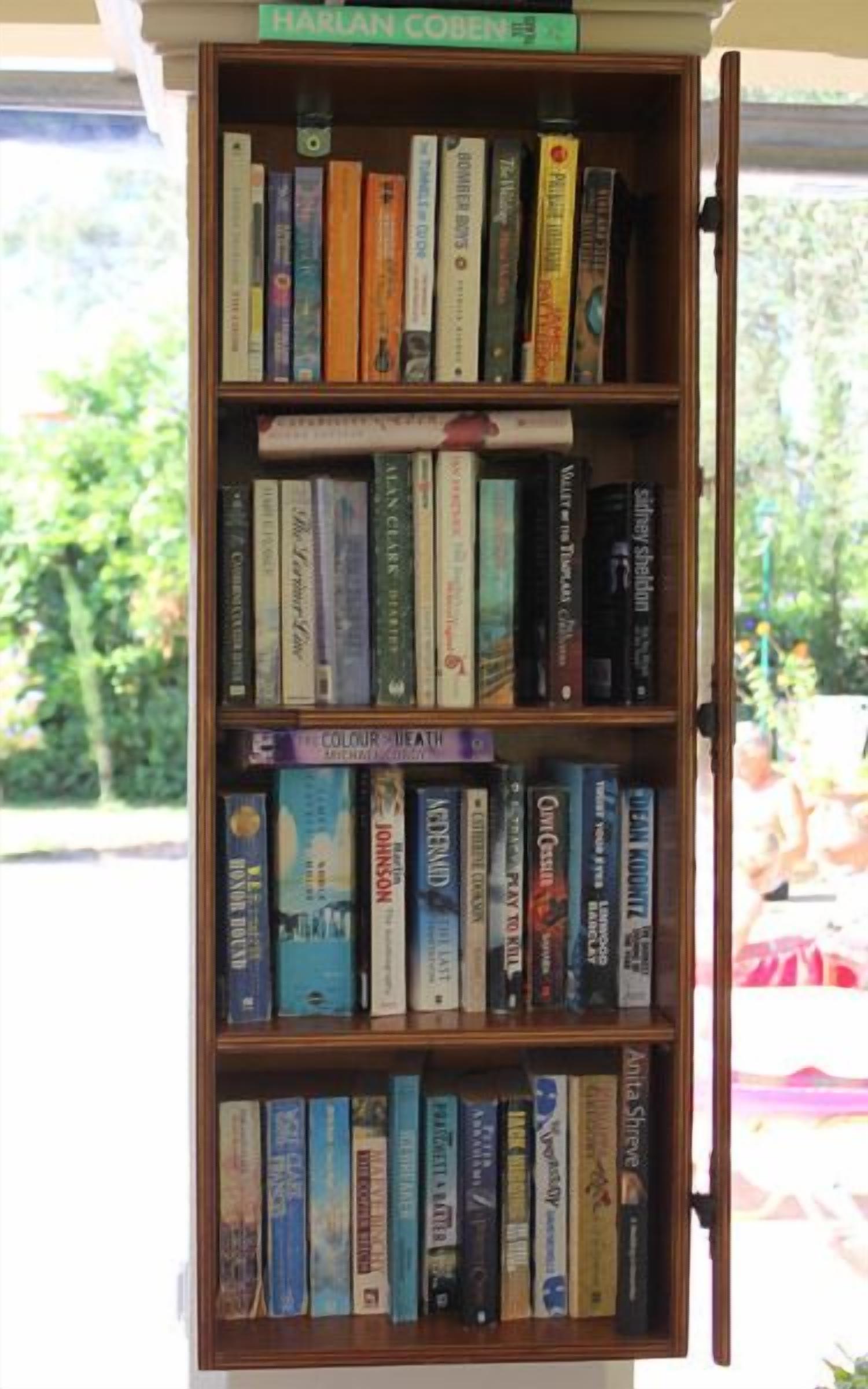 A bookshelf with various books, including titles like 'The Colour of Money' and 'The Colour of Money'.