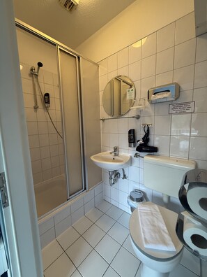 Shower, hair dryer, towels, shampoo