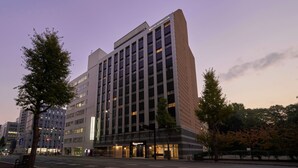 A modern hotel building with multiple floors, a prominent entrance, and a sign indicating it is part of the Hotel Horse Club. - Hotel Hokke Club Fukuoka (Fukuoka)