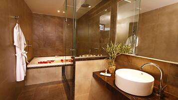 A modern bathroom with a bathtub, a sink, and a glass shower enclosure.