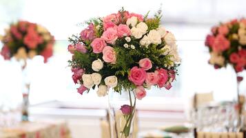 A bouquet of pink and white roses in a clear vase.