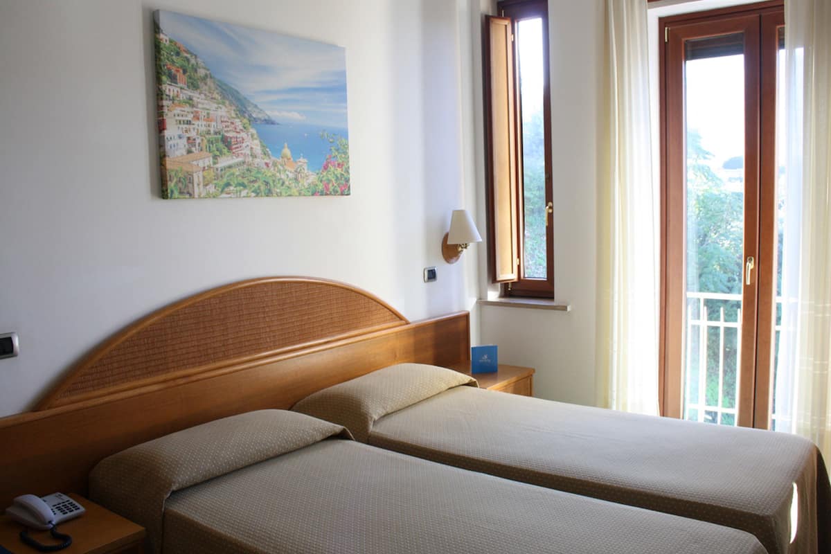 Twin Room, Partial Sea View | Minibar, in-room safe, desk