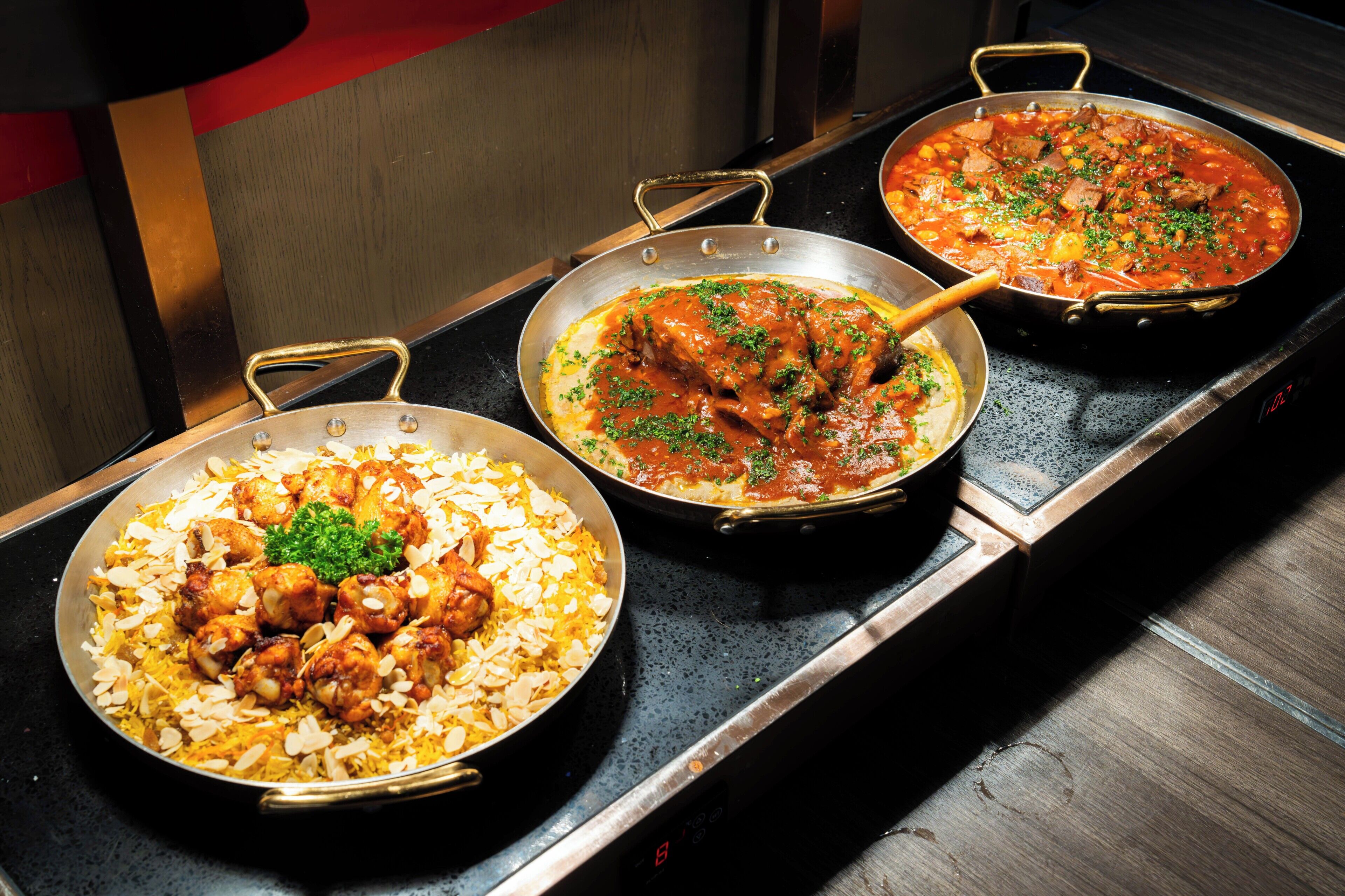 Three dishes on a stove.
