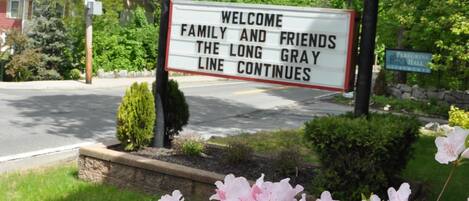 A motel sign with a red and yellow logo, welcoming guests to the West Point Motel.