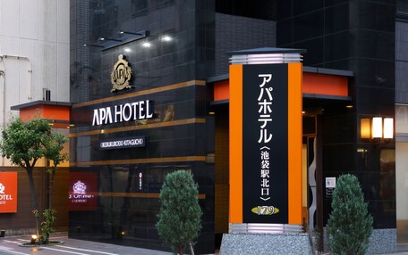 The exterior of APA Hotel with a prominent entrance and signage in Japanese.
