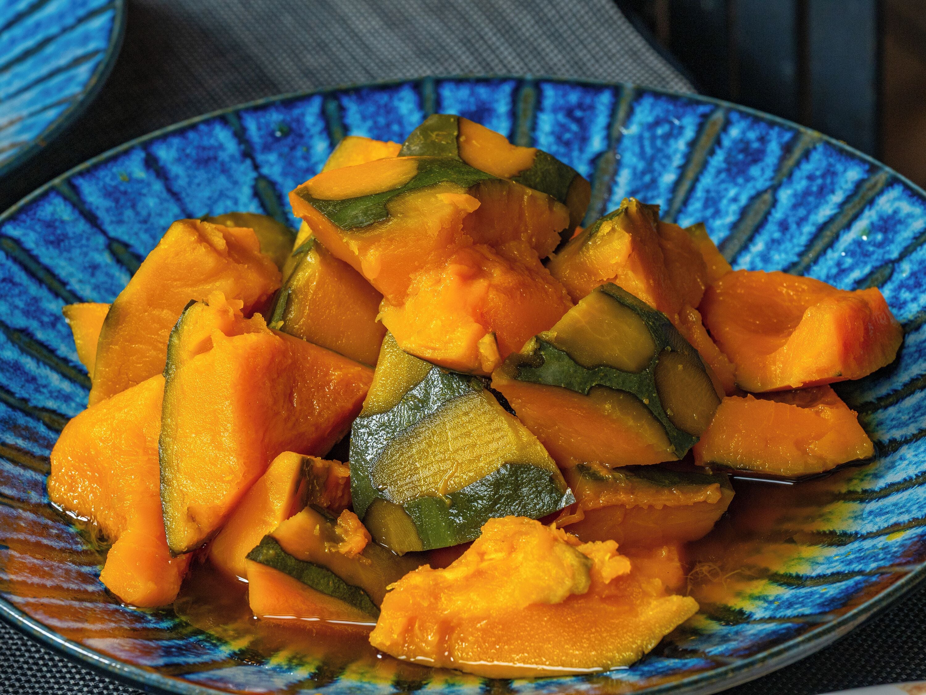 A bowl of cubed mango and zucchini.