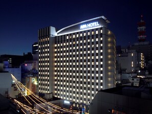 A modern hotel with a prominent 'APA HOTEL' sign, featuring a grid of windows and a flat roofline. - APA Hotel Nagoya Sakae (Nagoya)