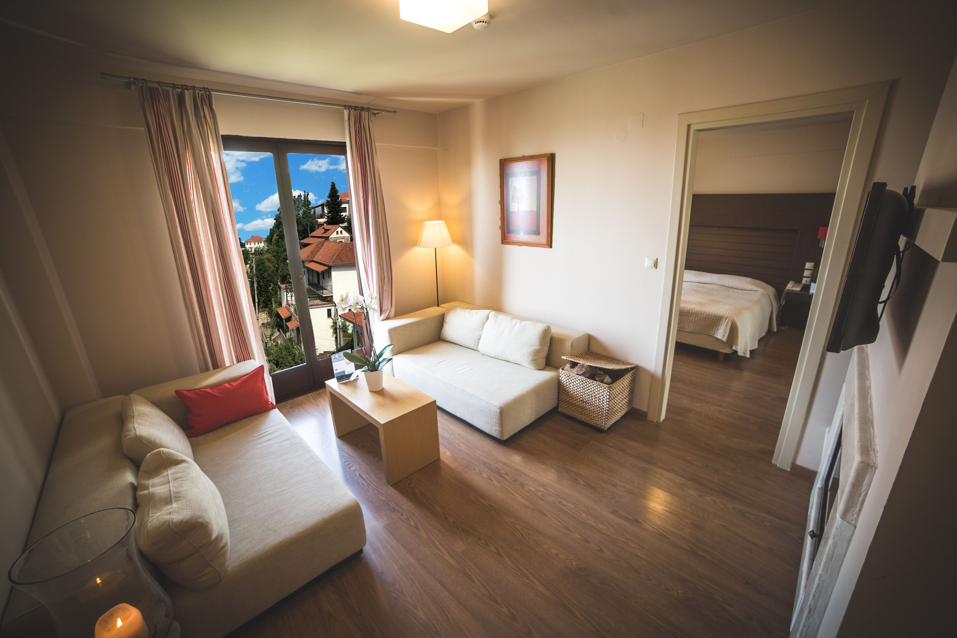suite with balcony and portaria view | living area | 32-inch flat-screen tv with satellite channels, tv, books