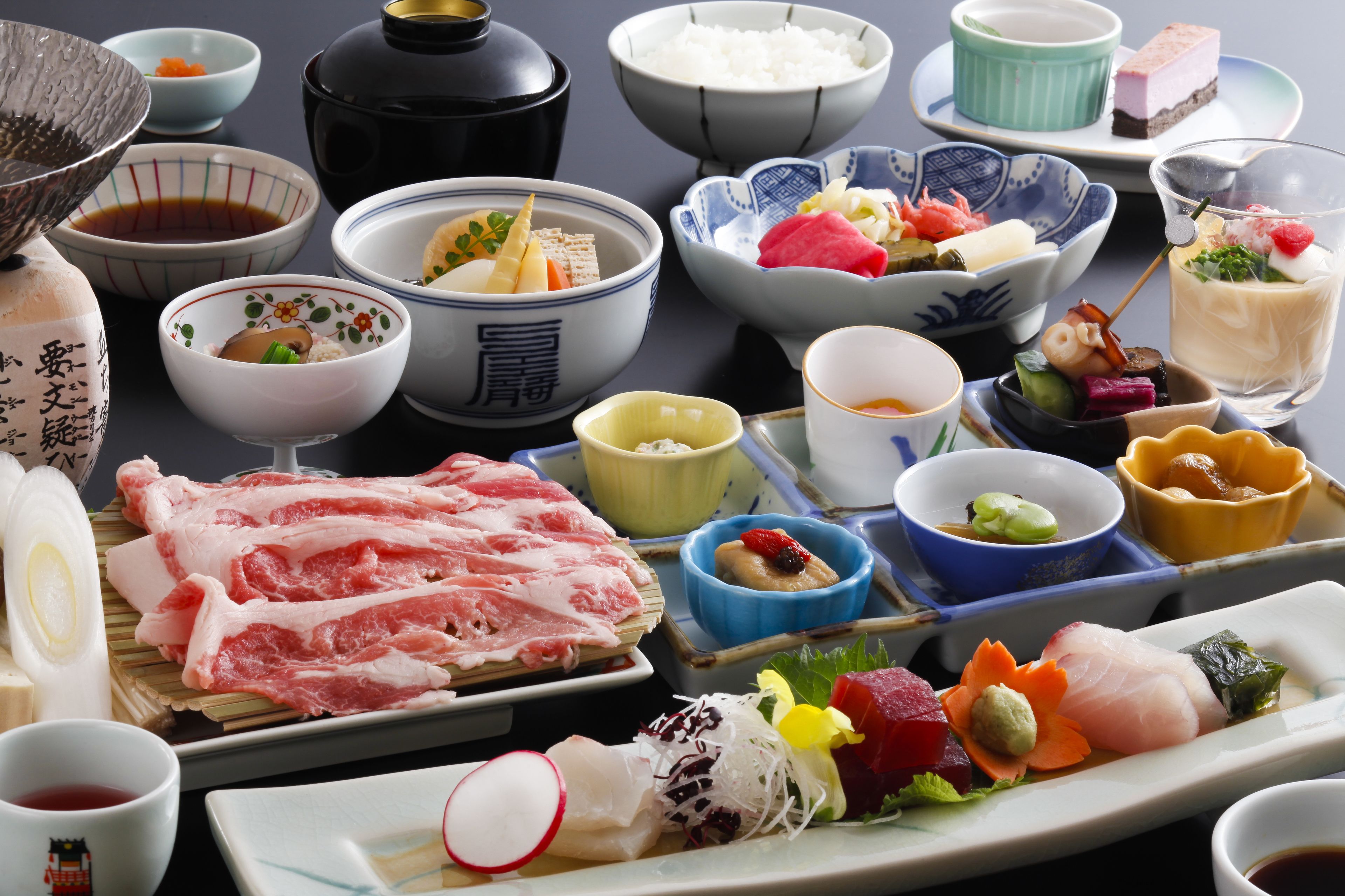 A variety of Japanese dishes including sushi, sashimi, and rice bowls.