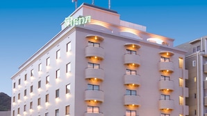 A multi-story hotel with a prominent sign at the top. - Hotel Piena Kobe (Kobe)
