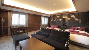 A hotel room with a large bed, a sofa, a desk, and a chair. - Hotel Piena Kobe (Kobe)