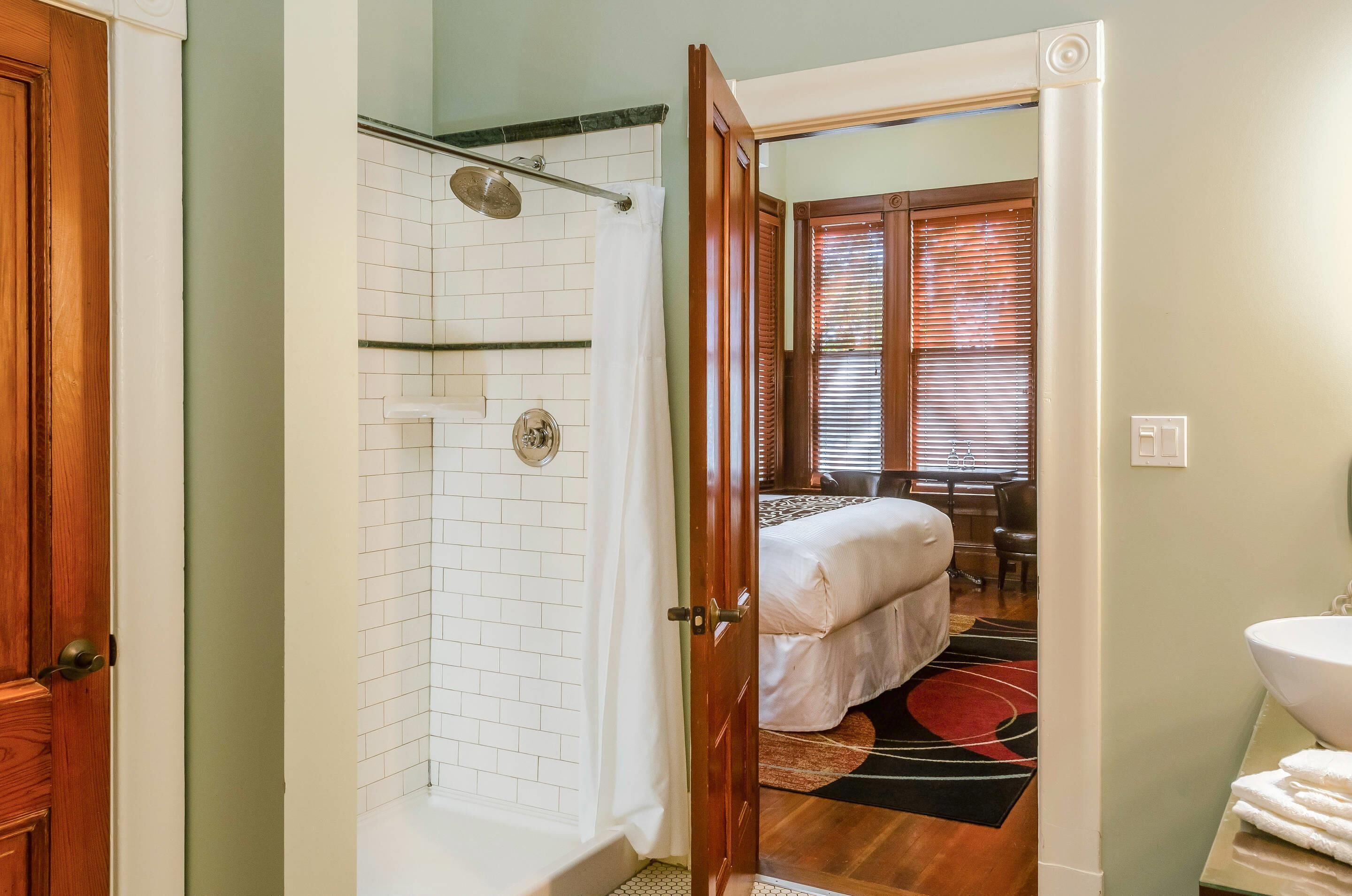 A bathroom with a shower, toilet, and sink.