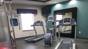 A gym with treadmills, an elliptical, and a red exercise ball. - Hampton Inn & Suites Center (Center)