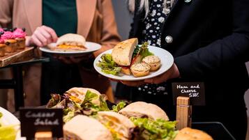 A food display with sandwiches and a sign indicating 'Ham and Cheese S.W.'