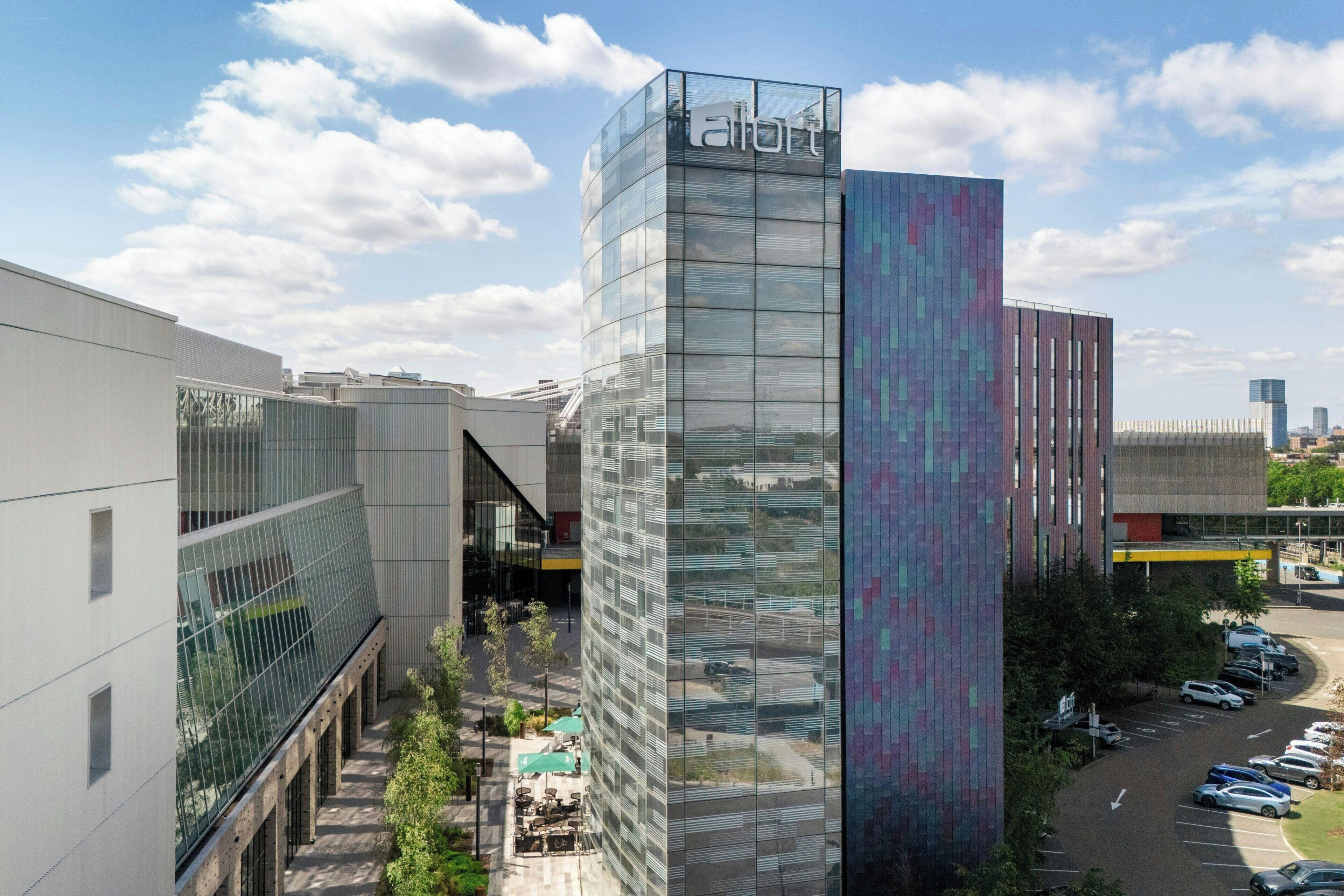 A modern building with a glass facade and a sign that reads 'effort'.