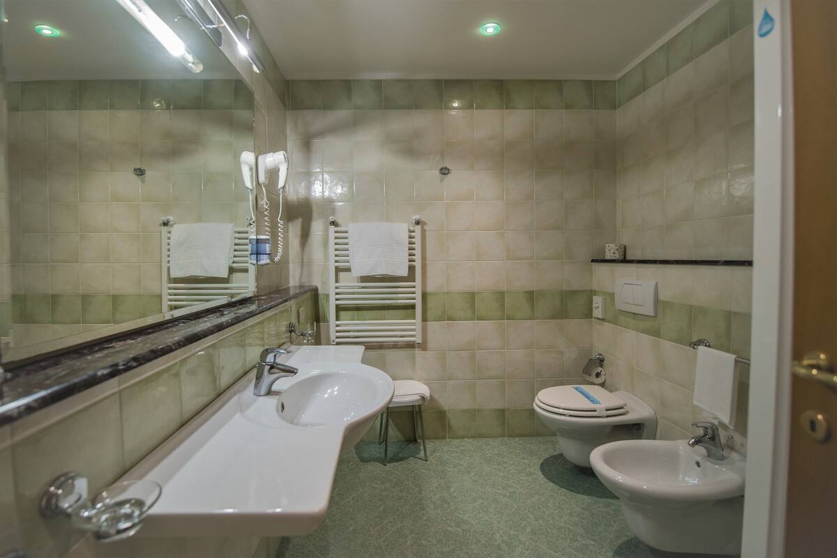 comfort room | bathroom | hair dryer, bidet, towels