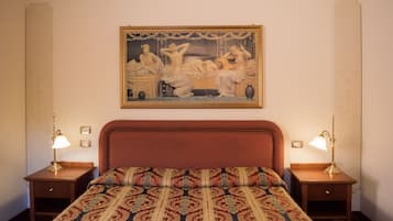A hotel room with a large bed, two bedside tables, and a classic painting on the wall.