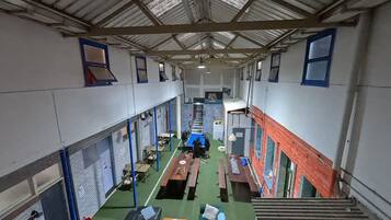 A multi-level indoor space with various seating areas, tables, and a staircase.