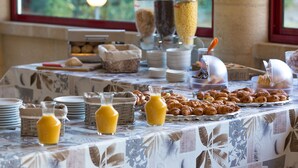A breakfast buffet with various food items and beverages.