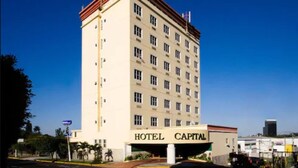 A multi-story hotel building with a prominent "HOTEL CAPITAL" sign at the entrance.