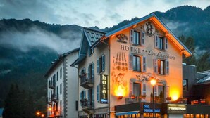 A hotel with a sign reading "HOTEL Les Lanchers" and a restaurant named "bar restaurant" adjacent to it. - Hotel Les Lanchers (Chamonix-Mont-Blanc)