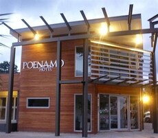 Un hotel moderno con facciata in legno e ampie vetrate.