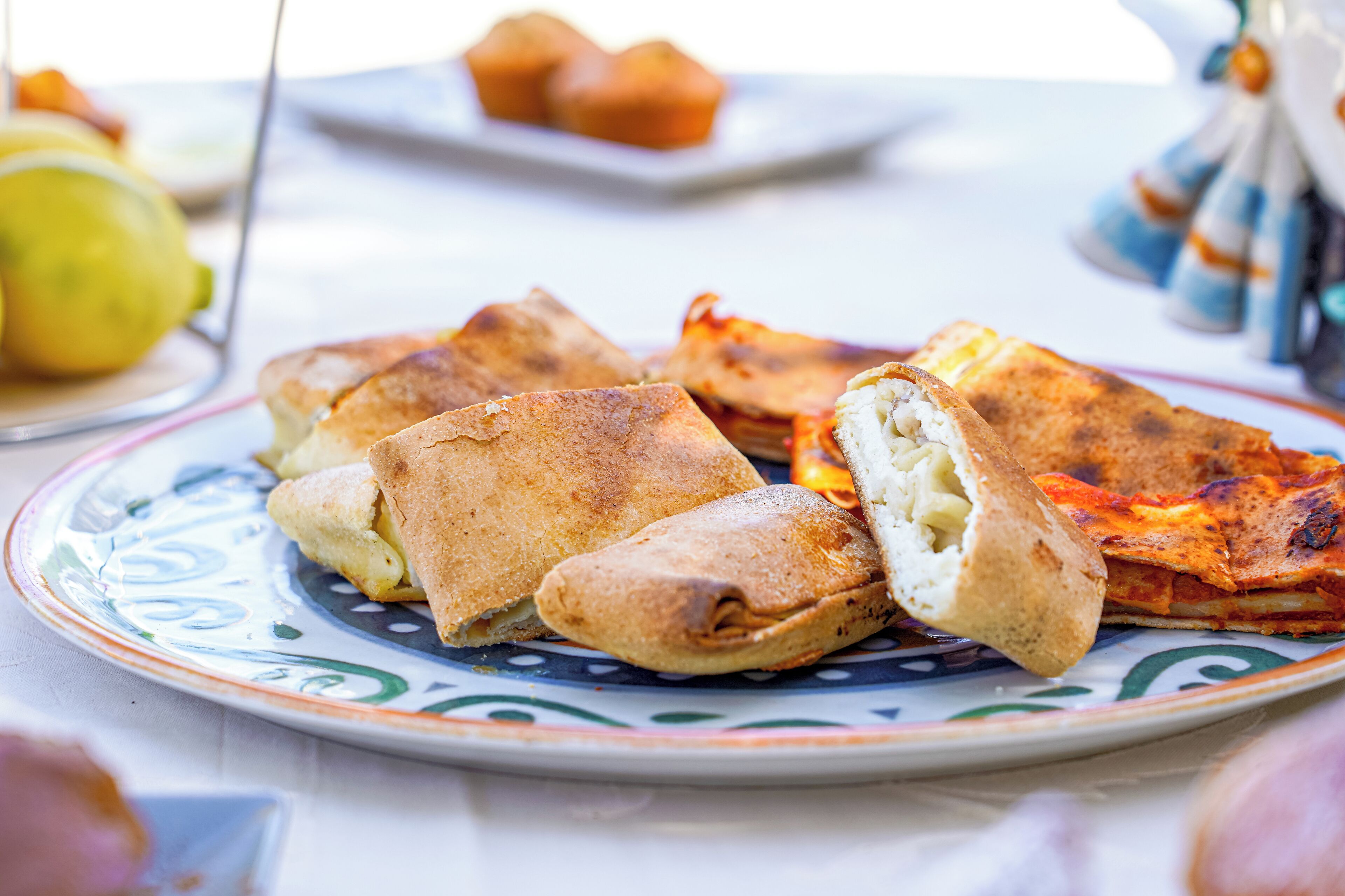A plate of stuffed flatbreads with a decorative plate.