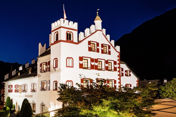 A large, castle-like building with multiple windows and a prominent tower.
