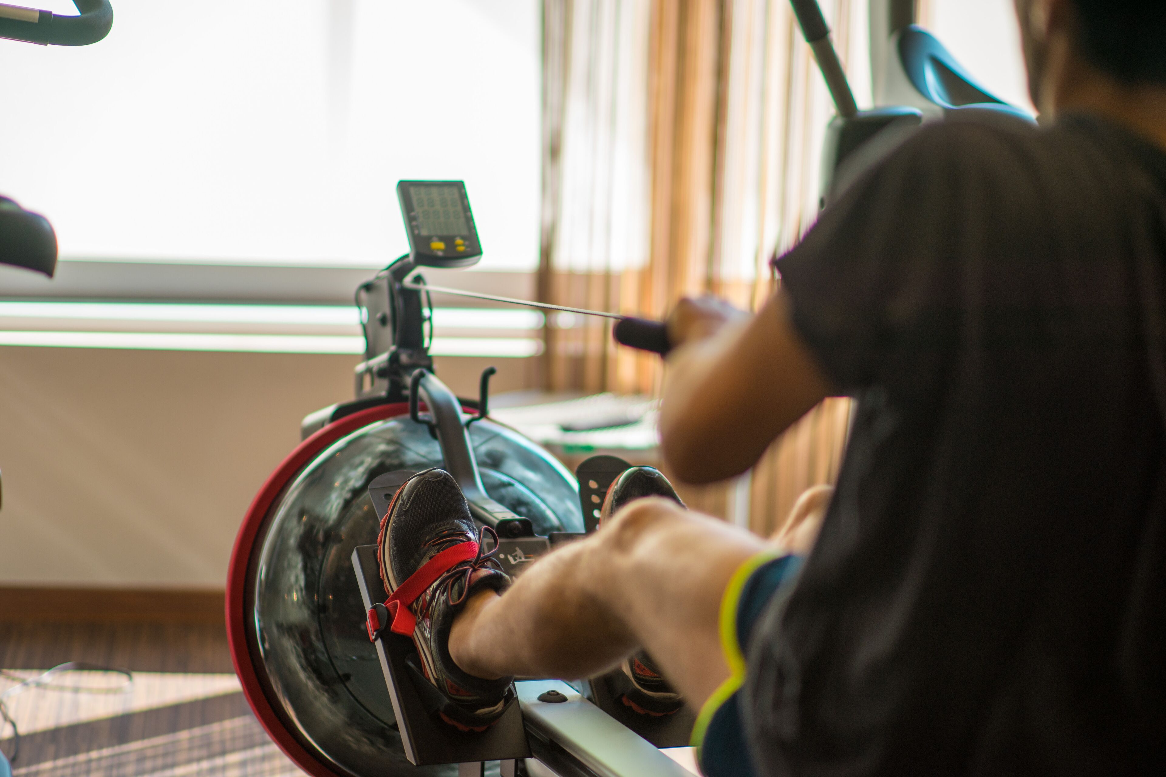 A stationary bike with a digital display and a user pedaling.