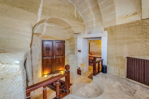 Luxury Cave Suite with Turkish Bath | Living area | 60-cm plasma TV with satellite channels, TV, fireplace
